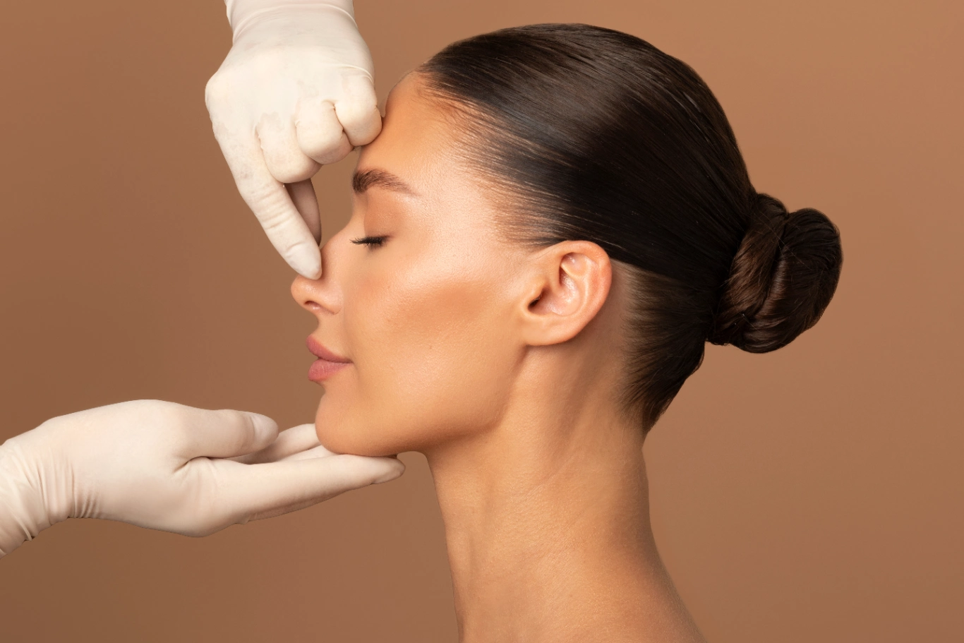 natural nose refinement side profile Person receiving facial assessment by gloved professional highlighting nose contour smooth skin background